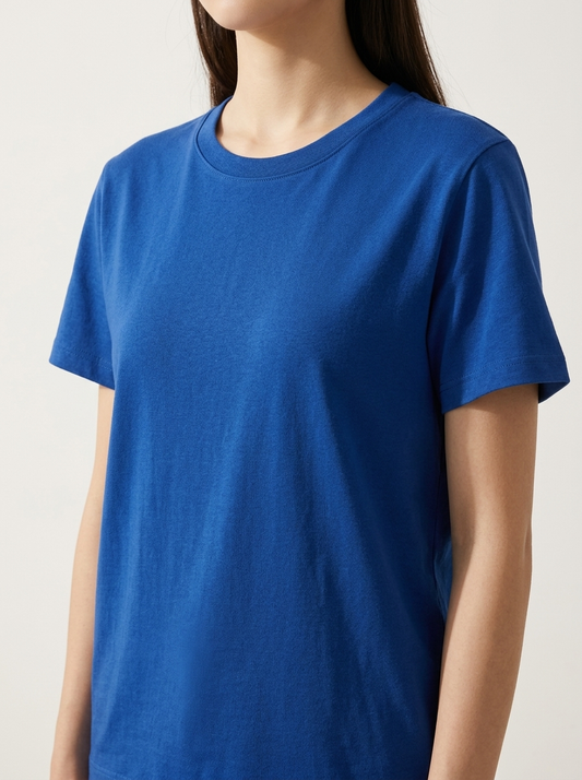 woman wearing a blue t-shirt against a plain background