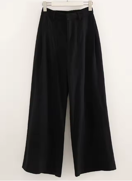 Black wide-leg pants on a hanger against a white background